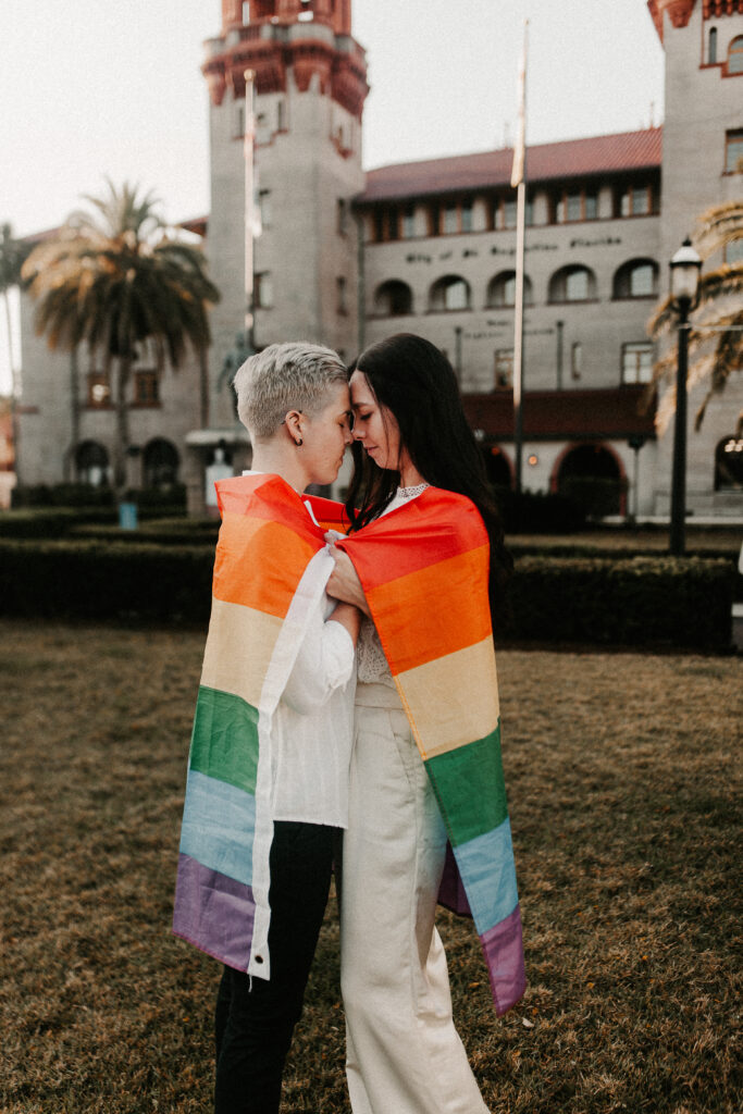 LGBTQ+ elopement in St. Augustine Florida in front of the Lightner Museum with the rainbow flag