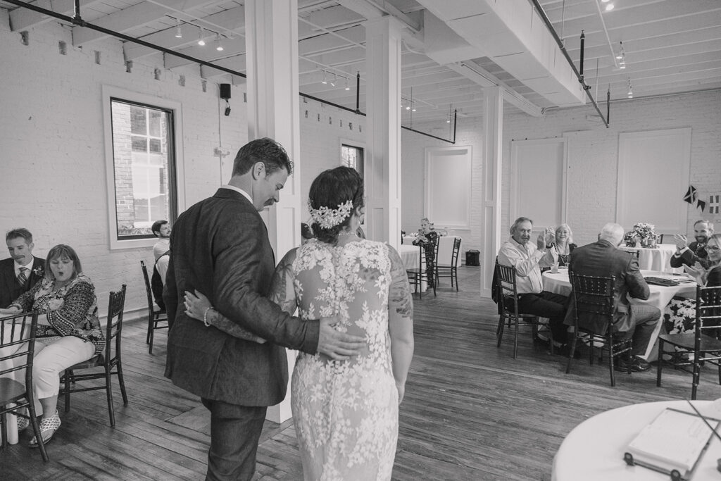 Couple walking into their reception at a local brewery in jacksonville florida