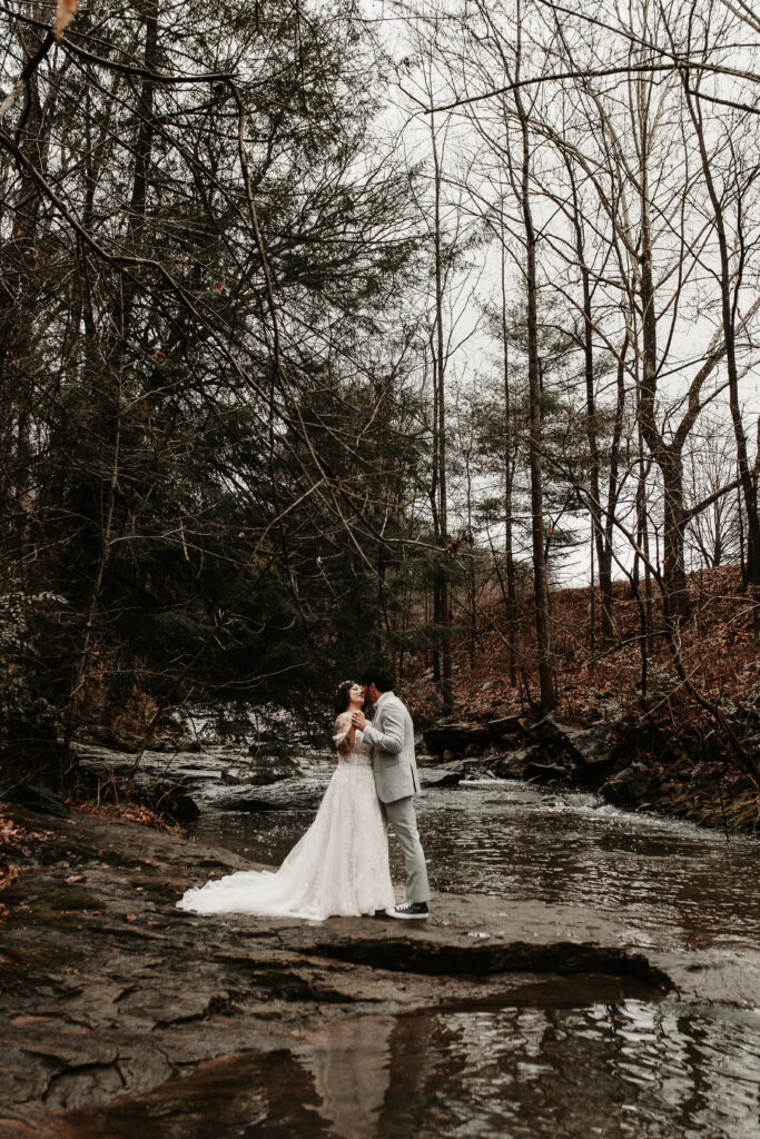 Bride and Groom along the river banks in Asheville North Carolina at the botanical gardens