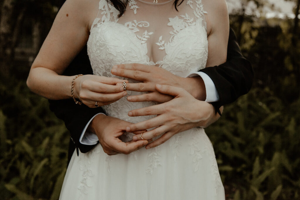 Artistic photo of a couple exchanging wedding rings.