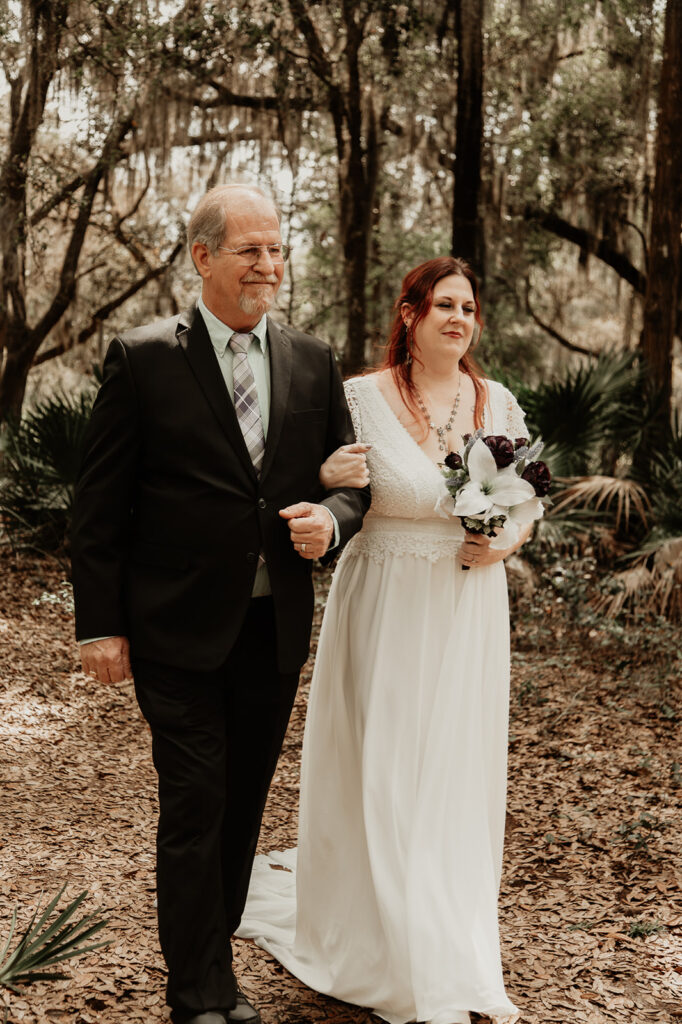 bride and her father walking down the isle during her florida garden elopement