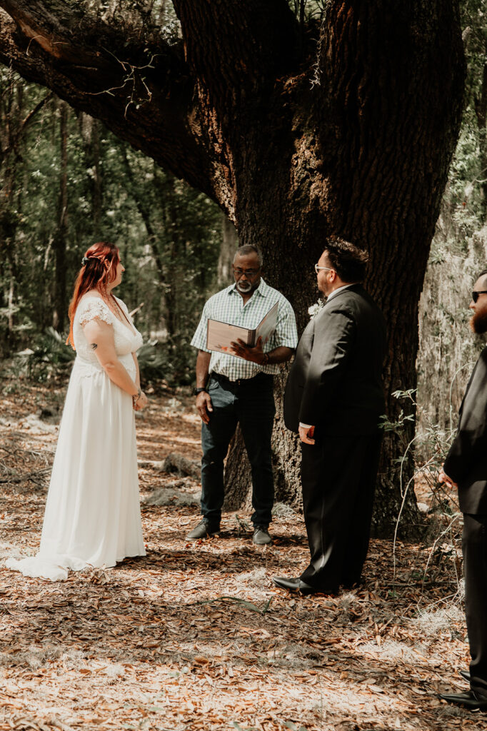 bride and groom at their ceremony during their botanical garden elopement in florida