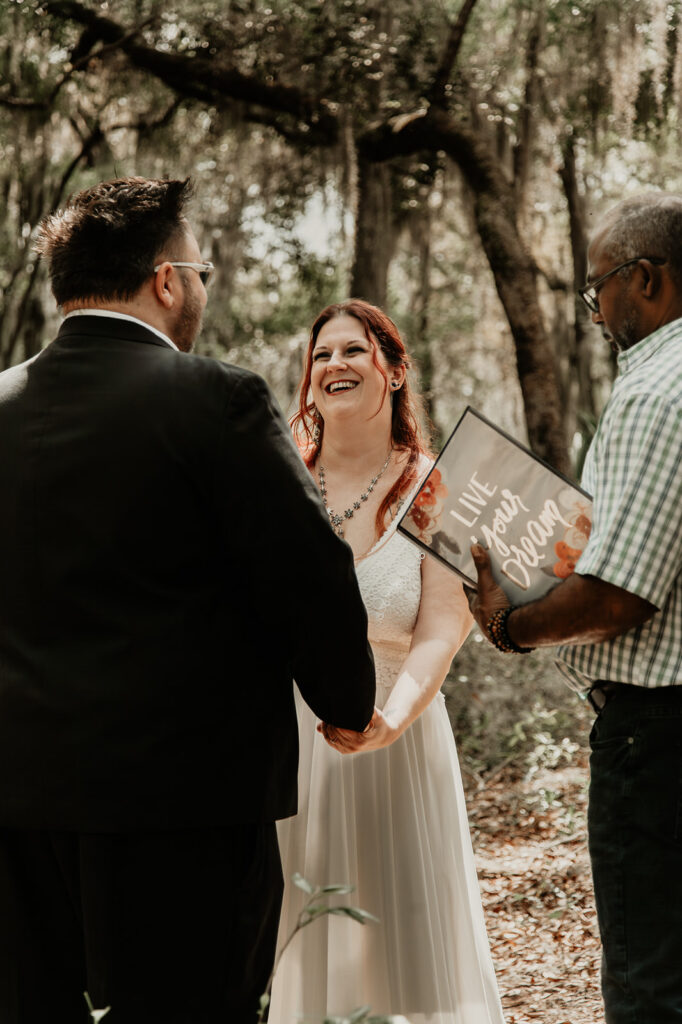 bride at the ceremony during her  botanical garden elopement in florida