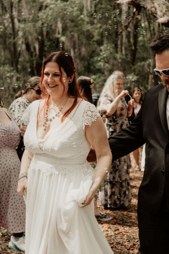 bride and groom after their  botanical garden elopement in florida with bubbles