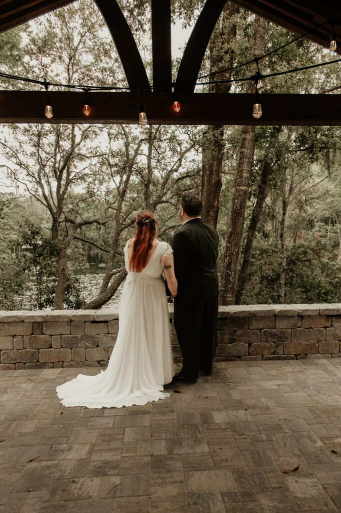 bride and groom staring out at the lake at the Jacksonville Botanical gardens in florida