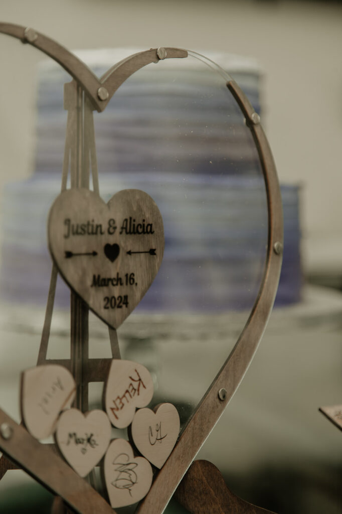 wedding guest book with the cake in the background