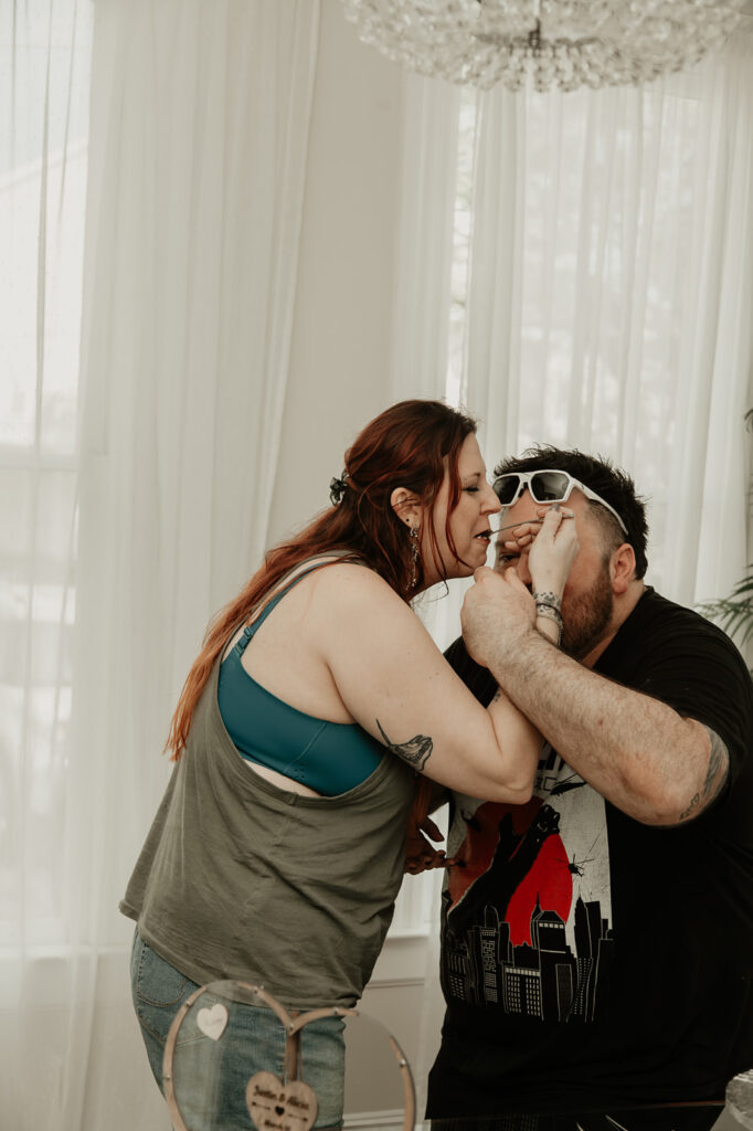 Bride and groom celebrate white sharing their wedding cake