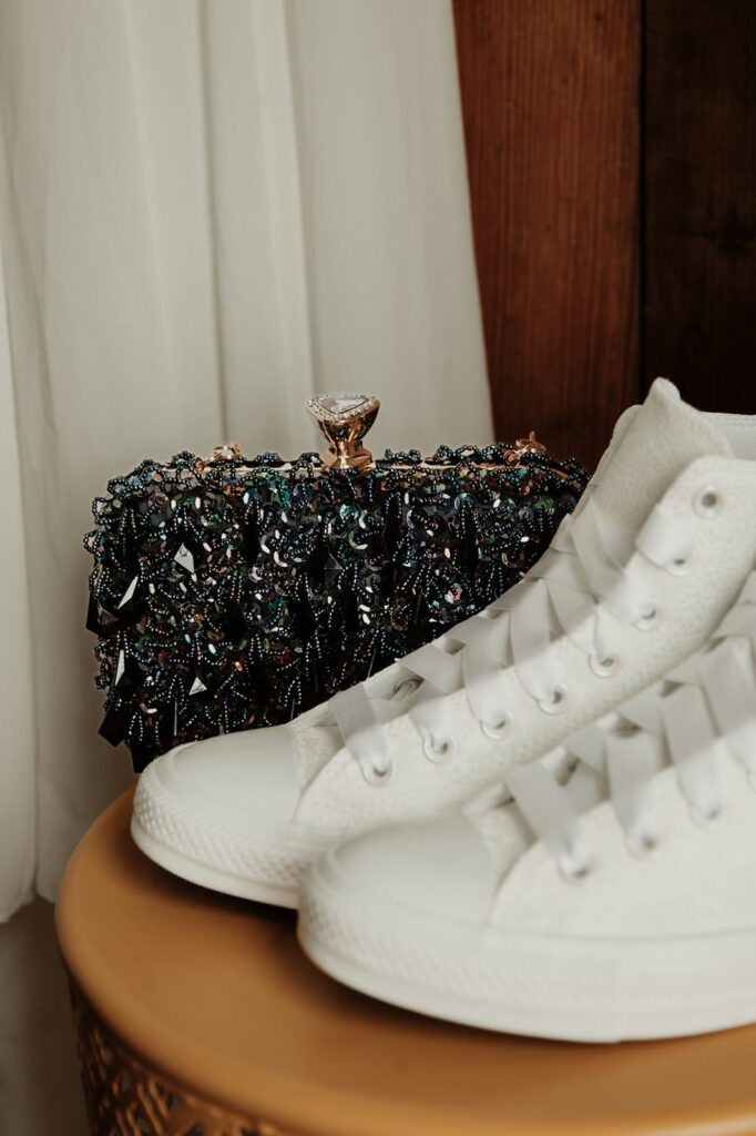 Wedding day clutch and converse detail shot