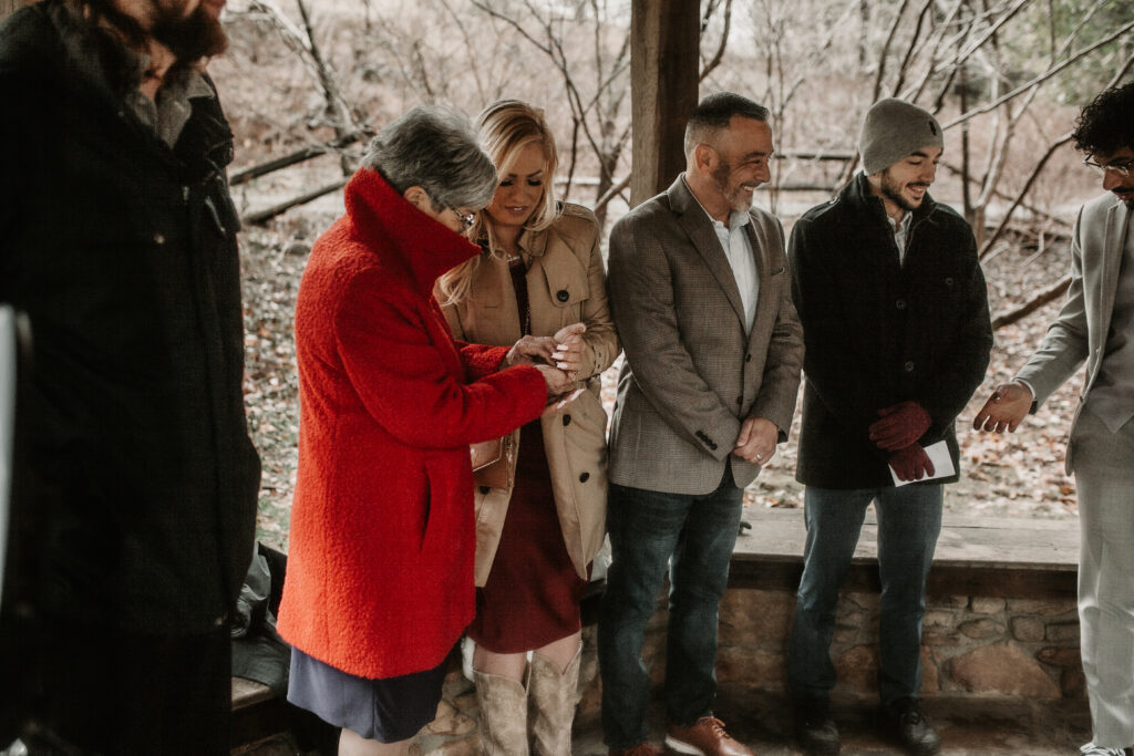 Guests passing around wedding rings during ring warming ceremony