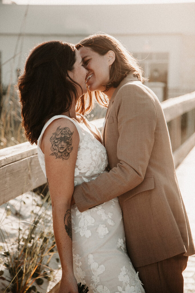 Brides Kissing at golden hour on the beach in St. Augustine