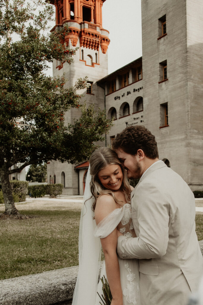 bride and groom are laughing at each other