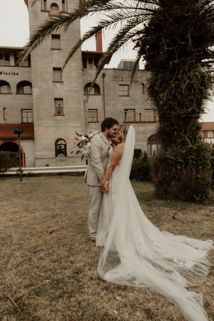 Bride and groom about to kiss in front of the Lightner museum in st Augustine Florida