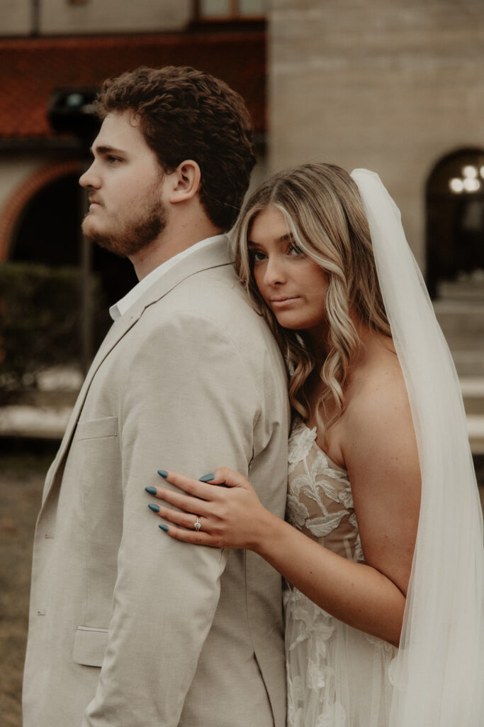 Bride standing behind groom during bride and groom portraits during their elegant st Augustine elopement