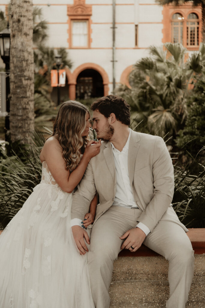 Bride and groom starring at each other with flagler college in the background