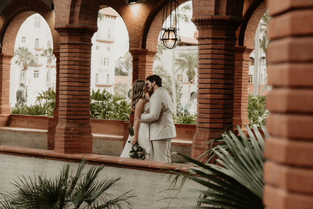 Bridge and Groom kissing in Flagler College Court Yard