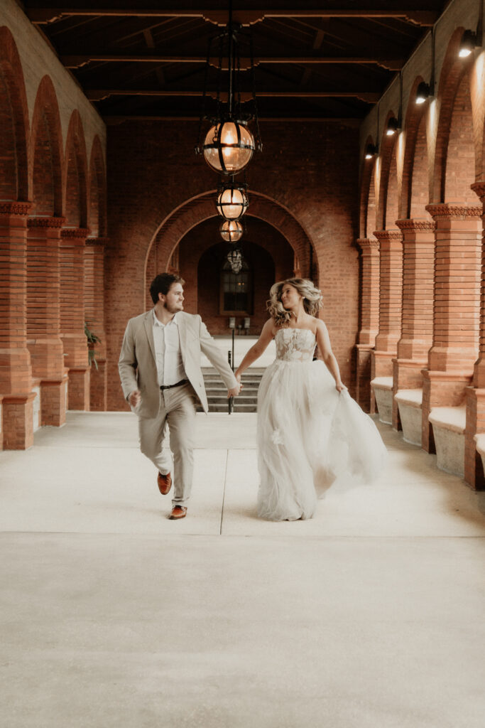 Bride and groom running through Flagler College