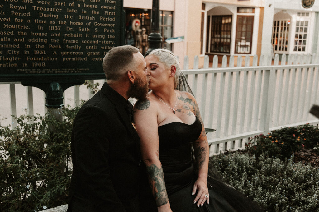 Bride and groom kissing on the St George Street in St Augustine in All black. 